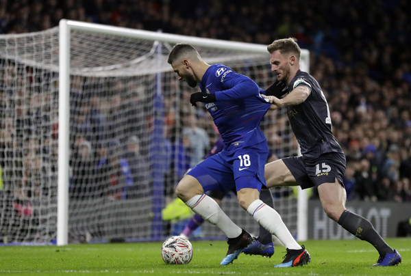 Chelsea's Olivier Giroud (left) duels for the ball with Sheffield Wednesday's Tom Lees during the English FA Cup fourth round soccer match between Chelsea and Sheffield Wednesday at Stamford Bridge stadium in London on Sunday.