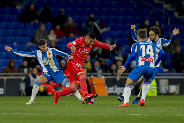 Real Madrid's midfielder Carlos Henrique Casemiro (14) fights for the ball during the match between RCD Espanyol and Real Madrid during the Spanish La Liga soccer at RCDE stadium in Cornella Llobregat, Spain on Sunday.