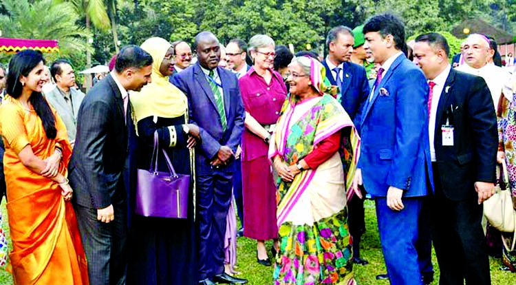 Prime Minister Sheikh Hasina exchanging pleasantries with the heads of mission, diplomats at a tea party hosted by the PM in their honour at Ganobhaban on Monday. BSS photo