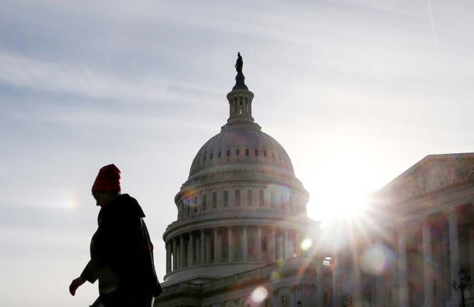 A visitor walks by the U.S. Capitol on day 32 of a partial government shutdown as it becomes the longest in U.S. history in Washington.
