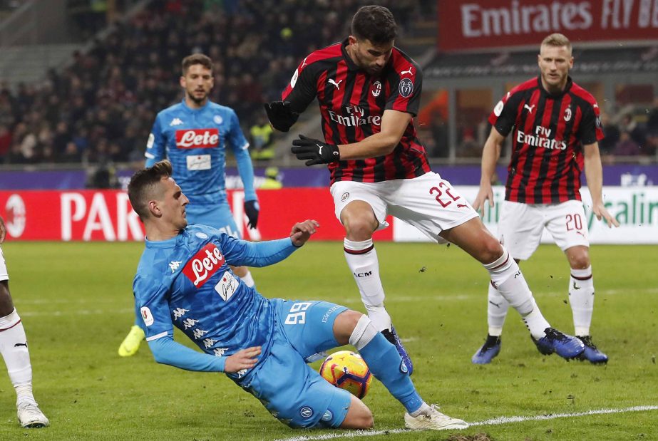 Napoli's Arkadiusz Milik (bottom) challenges for the ball with AC Milan's Mateo Musacchio during an Italian Cup quarter-final soccer match between AC Milan and Napoli at the San Siro stadium in Milan, Italy on Tuesday.