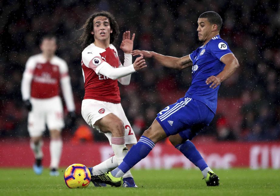Arsenal's Matteo Guendouzi (left) and Cardiff City's Lee Peltier during their English Premier League soccer match at the Emirates Stadium in London on Tuesday.