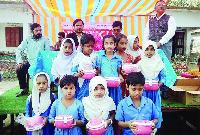 MURADNAGAR(Cumilla): Tiffin boxes distributed among the students of primary schools at Dhamghar Govt Primary School premises marking the Mothersâ€™ Gathering on Wednesday.