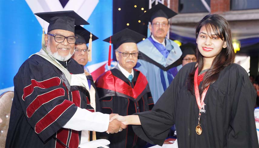 Liberation War Minister AKM Mozammel Huq, MP shaking hands with a graduate student of East West University at the 18th Convocation of the University held EWU campus in the city on Wednesday.