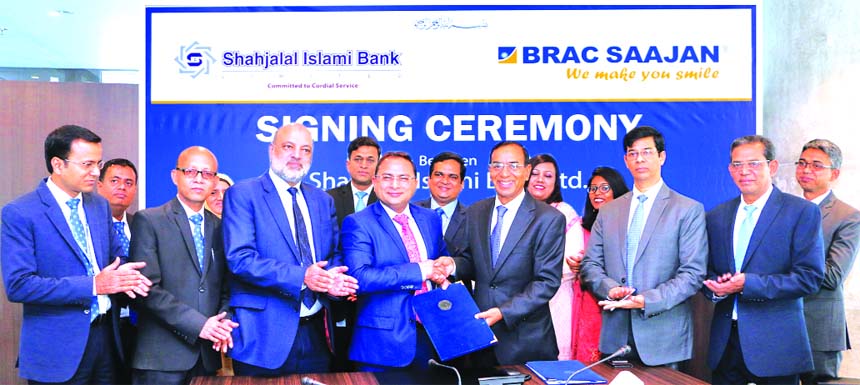 M Shahidul Islam, Managing Director of Shahjalal Islami Bank Limited (SIBL) and Abdus Salam, Managing Director of BRAC Saajan Exchange Limited, exchanging an agreement signing document at SIBL head office in the city recently. Under the deal, Bangladeshi