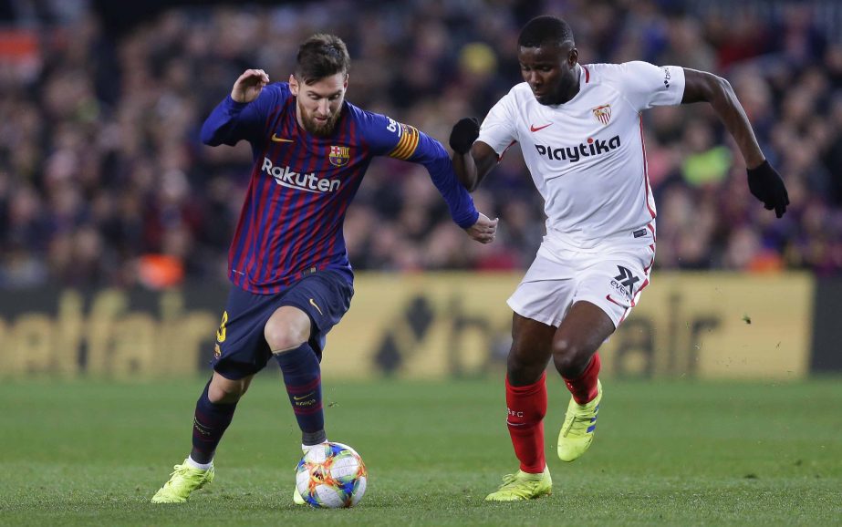FC Barcelona's Lionel Messi (left) duels for the ball with Sevilla's Ibrahim Amadou during a Spanish Copa del Rey soccer match between FC Barcelona and Sevilla at the Camp Nou stadium in Barcelona, Spain on Wednesday.
