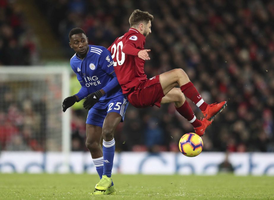 Liverpool midfielder Adam Lallana (right) is tackled by Leicester City midfielder Wilfred Ndidi during the English Premier League soccer match between Liverpool and Leicester City, at Anfield Stadium, Liverpool, England on Wednesday.