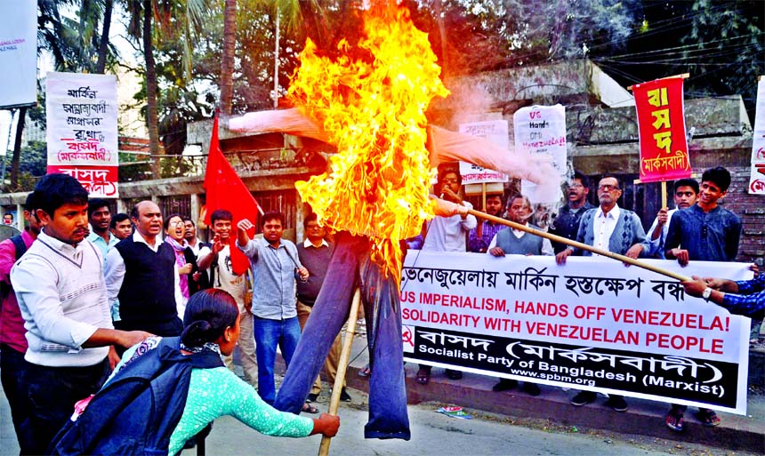 Bangladesher Samajtantik Dal (Marxist) burns the effigy of US President Donald Trump in front of the Jatiya Press Club on Friday with a call to stop US interference in Venezuela.