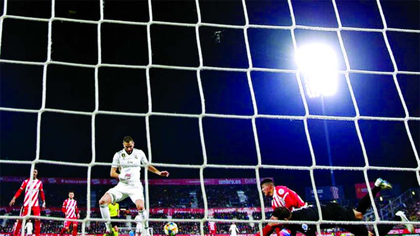 Real Madrid's Benzema (center left) in action during a Spanish Copa del Rey soccer match between Girona and Real Madrid at the Montilivi stadium in Girona, Spain on Thursday.