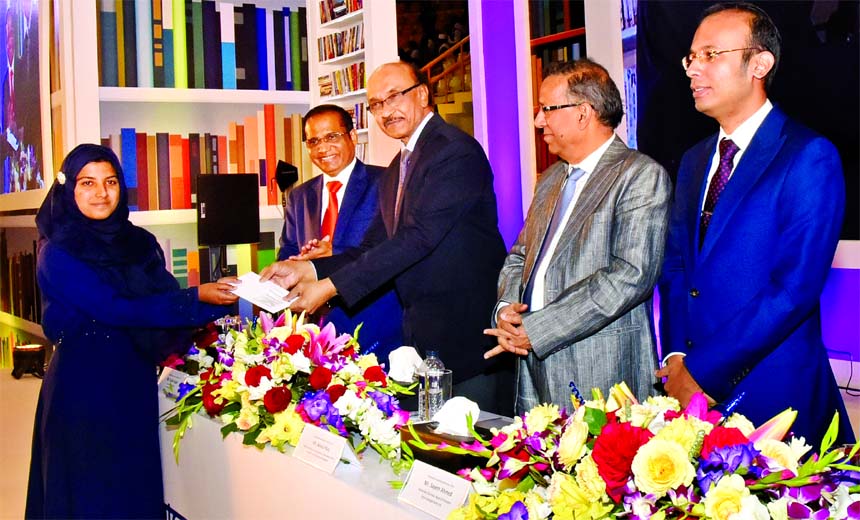 Bangladesh Bank Governor Fazle Kabir, handing over scholarship awarding letters among the students who passed HSCEquivalent Examination in 2018 and studying at Graduation level in different universitiescolleges of the country at a ceremony organized by
