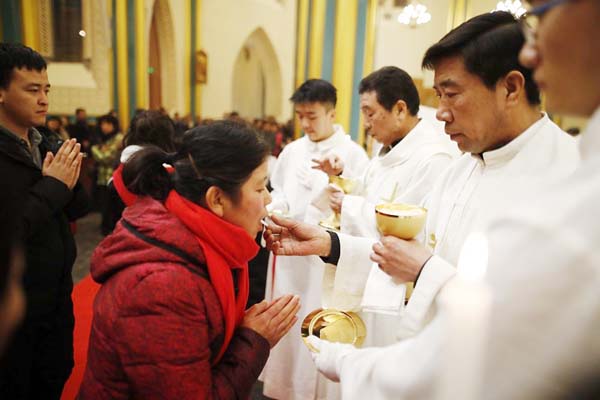 Chinese Catholic clergy prepare to attend a mass during Christmas Eve at a Catholic church in Beijing.