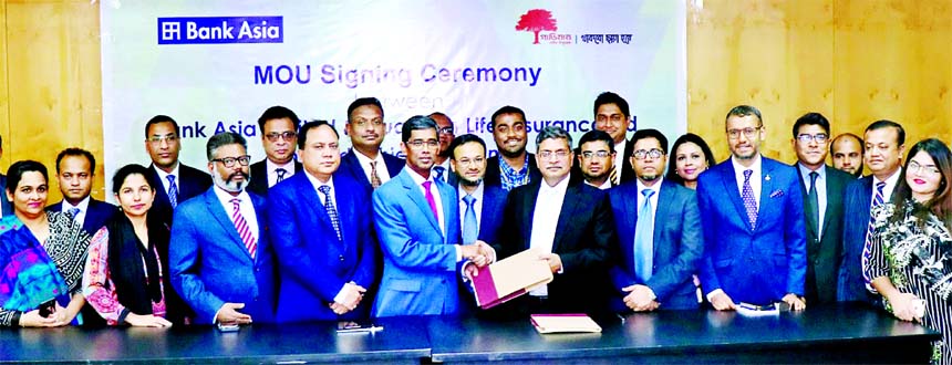Md. Arfan Ali, Managing Director of Bank Asia Limited and M M Monirul Alam, CEO of Guardian Life Insurance Limited, exchanging a contract signing document to ensure all the unsecured loans disbursed by the Bank at its head office in the city recently. Muh