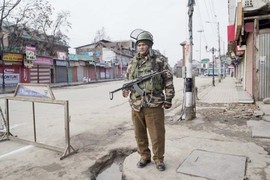 An Indian paramilitary soldier stands guard near a temporary check point during a strike in Srinagar, Indian controlled Kashmir on Sunday.