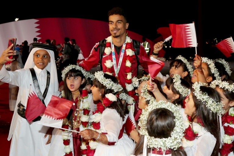 Qatar forward Akram Afif poses for a photograph at Doha airport on Saturday as the national football team return from the United Arab Emirates with the trophy after winning the 2019 AFC Asian Cup football tournament.