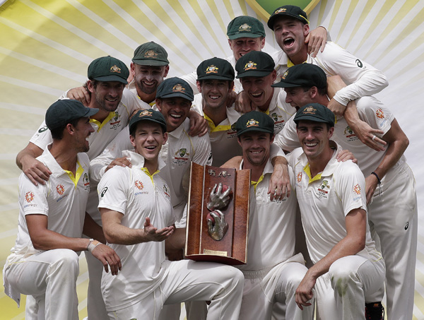 The Australian team pose with their trophy after defeating Sri Lanka on day 4 of their cricket Test match in Canberra on Monday. Australia won the Test by 366 runs and the series 2-0.