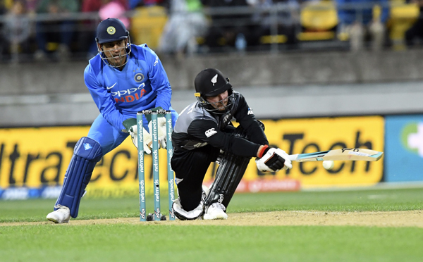 New Zealand's Tim Seifert (right) sweeps in front of India's MS Dhoni during the twenty20 cricket international between New Zealand and India, in Wellington, New Zealand on Wednesday.