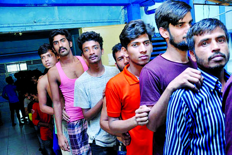 Bangladesh men stand as they arrive at immigration detention center in Medan, North Sumatra, Indonesia. Internet photo