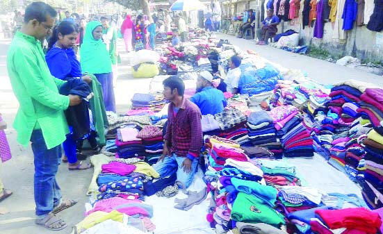 RANGPUR: Customers buying winter clothes at makeshift shops in Rangpur city .
