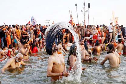Naga Sadhus or Hindu holy men take a dip during the first "Shahi Snan" (grand bath) at "Kumbh Mela" or the Pitcher Festival, in Prayagraj, previously known as Allahabad, India.