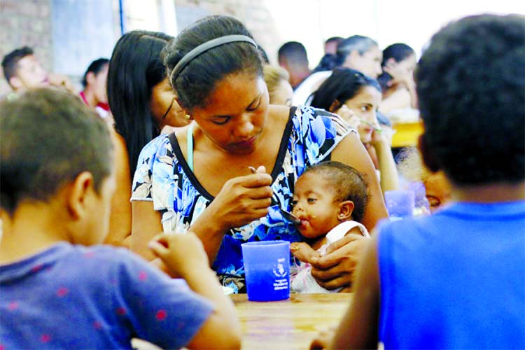 A Venezuelan migrant feeds her child at the Divina Providencia migrant shelter in Cucuta, Colombia, on the border with Venezuela.