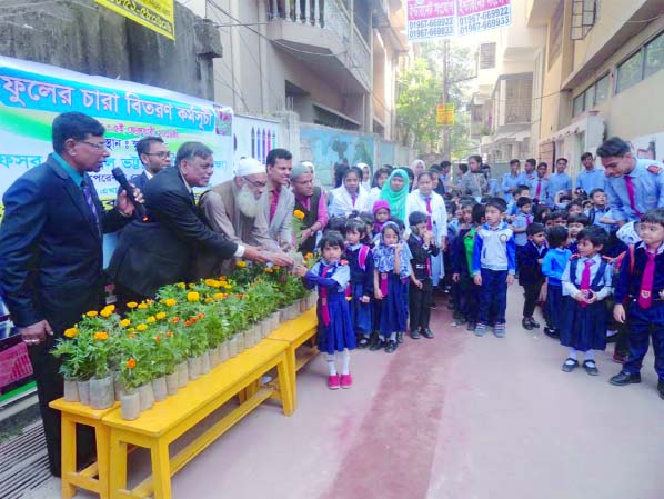 Chairman of Chattogram Sikkhak Kalyan Federation Principal Dr Abdul Karim inaugurating flower saplings distribution programme among the children at Parents Care School & College through distributing saplings as Chief Guest recently.