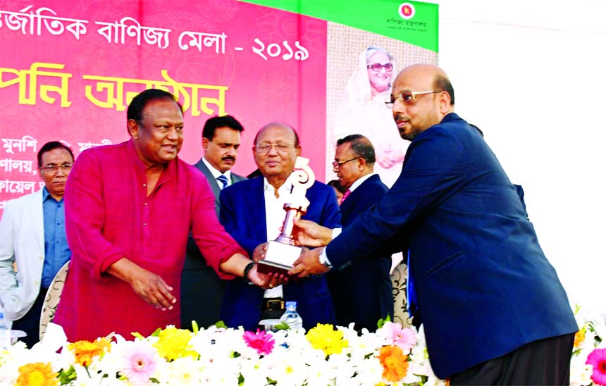 Abu Reza Md. Yeahia, DMD of Islami Bank Bangladesh Limited, receiving the prize of best premier pavilion for installing eye-catching pavilion at Dhaka International Trade Fair-2019 at from Commerce Minister Tipu Munsi, at DITF premise in its concluding se