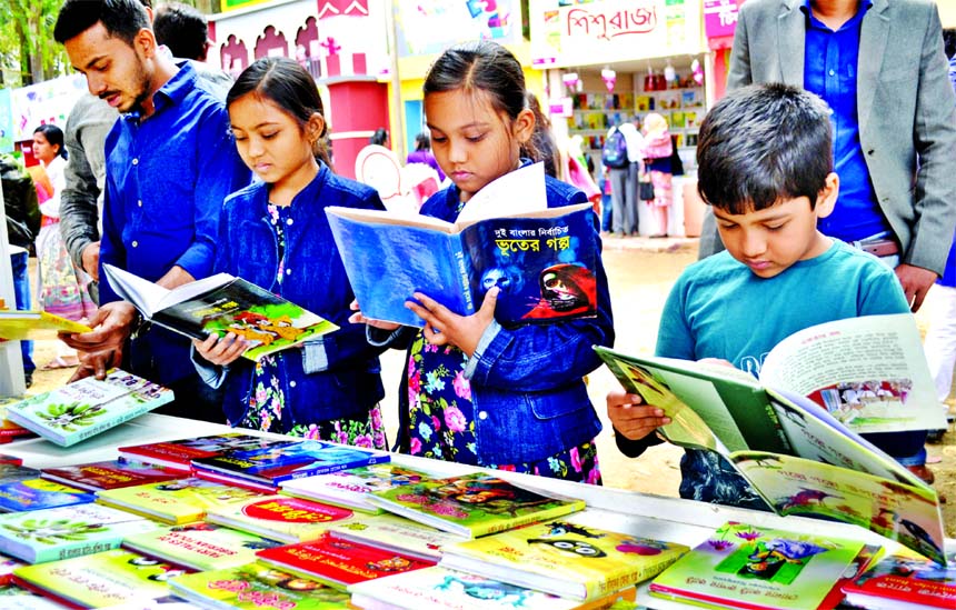 Children's corner abuzz with young book-worms at Ekushey Book Fair on Saturday.