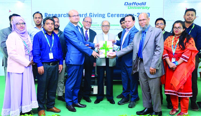 Prof Abdul Mannan, Chairman, University Grants Commission of Bangladesh (UGC) handing over the best Research Award winning department to Prof Dr. Touhid Bhuiyan, Head, Department of Software Engineering (SWE). Dr Md Sabur Khan, Chairman, Board of Truste