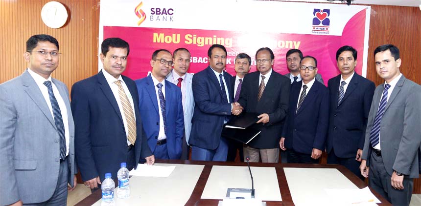 Tariqul Islam Chowdhury, DMD of South Bangla Agriculture and Commerce (SBAC) Bank Limited and Prof. Dr. Md. Abu Shamim, Director of Al Helal Specialized Hospital Limited, exchanging a MoU signing documents at the Banks head office in the city recently. Un