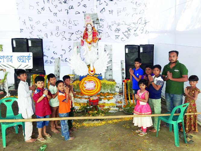 SIRAJDIKHAN(Munshiganj): Students offering prayer at a Puja mandap at Sirajdikhan Upazila in observance of the Saraswati Puja on Sunday.