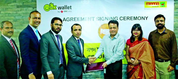 Gazi Yar Mohammed, Head of Digital and Inclusive Financial Services of ONE Bank Limited and Shaheen Khan, CEO of Meena Bazar (a concern of Gemcon Group), exchanging an agreement signing document at Gemcon Group's head office in the city recently. Under t