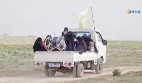 Civilians flee fighting near Baghouz, Syria. Fierce fighting was underway Monday between U.S.-backed Syrian forces and the Islamic State group around the extremists' last foothold in eastern Syria.