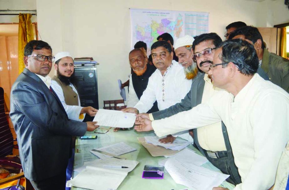 ULIPUR(Kurigram ): Golum Hossain Montu, General Secretary of Ulipur Awami League submitting nomination paper of chairman of Ulipur Upazila Parishad Election to Md Abdul Kader, UNO on Monday.