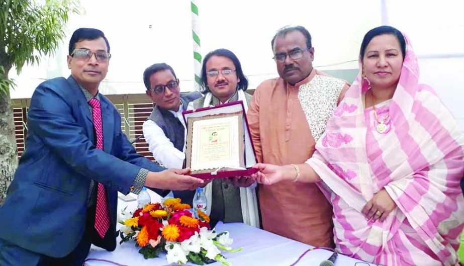 MANIKGNAJ: Md Akram Hossain, Headmaster of Singair Govt High School and Anwara Khatun, Upazila Woman Vice Chairman presenting crest to best scout teacher Md Altaf Hossain, Chairman, of Manikganj District Green Club at the annual Milad Mahfil and