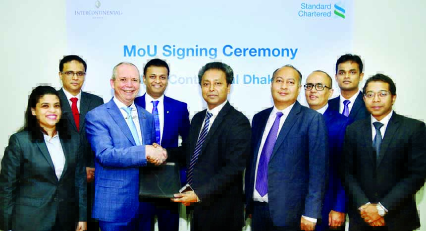 Lutful Habib, Acting Head, Retail Banking, Standard Chartered Bank and James P. McDonald, General Manager of InterContinental Dhaka, exchanging an agreement document at the hotel recently. The Bank's Signature, Platinum, Titanium credit card and Priority
