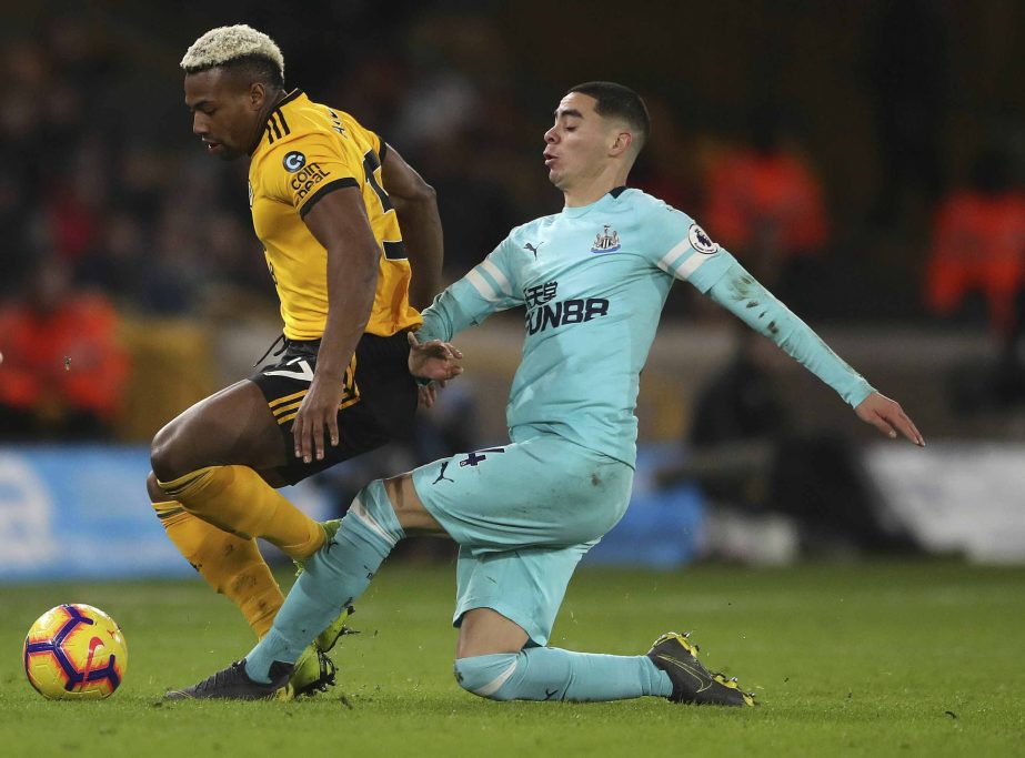 Wolverhampton Wanderers' Adama Traore and Newcastle United's Miguel Almiron (left) battle for the ball during the Premier League match at Molineux, Wolverhampton on Monday.