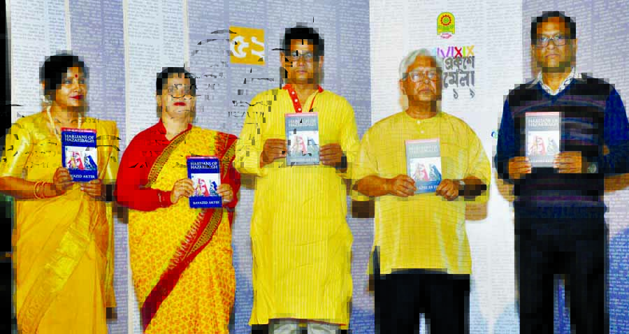 Prof Dr. Ahmed Kamal, among others, holds the copies of a book titled 'Harijans of Hazaribagh' written by photo journalist Bayazid Akter at its cover unwrapping ceremony on Bangla Academy Book Fair premises in the city on Thursday.