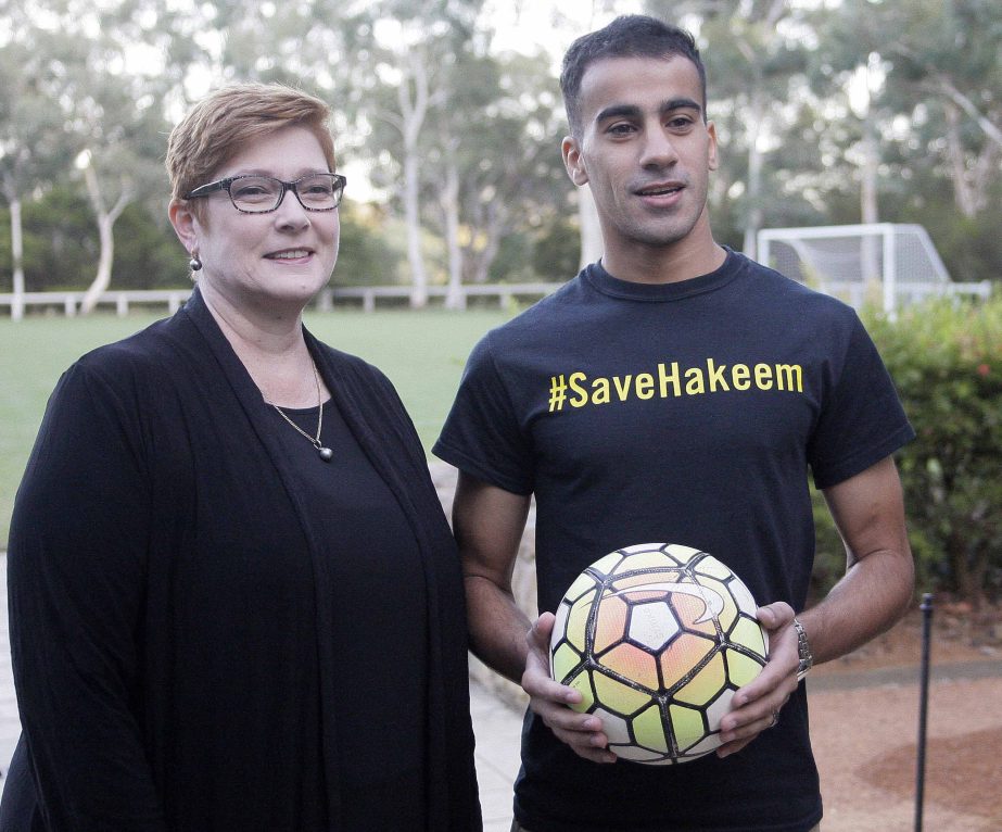 Australian Foreign Minister Marise Payne (left) and refugee soccer player Hakeem al-Araibi pose for a photograph before a soccer match at Parliament House in Canberra, Australia on Thursday. Al-Araibi was detained in Thailand for three months under threat