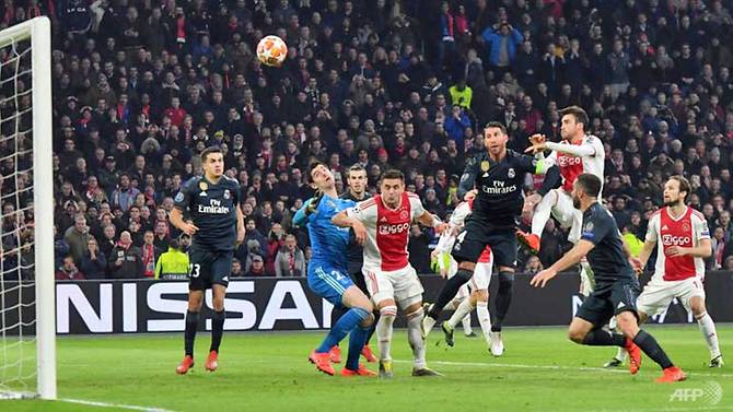 Ajax's Argentine defender Nicolas Tagliafico (3rd right) scores a goal which was rejected after VAR deliberation during the UEFA Champions league round of 16, first leg football match between Ajax Amsterdam and Real Madrid, in Amsterdam on Wednesday.