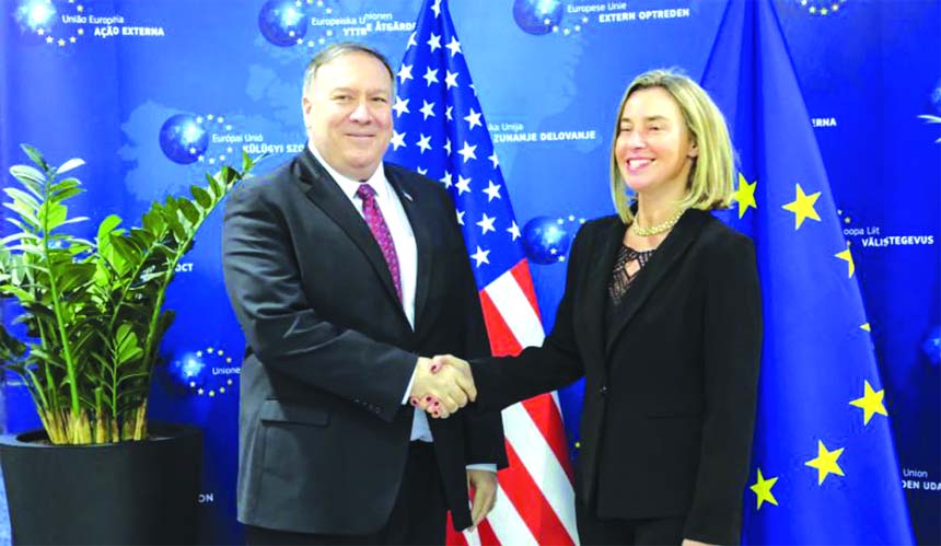 U.S. Secretary of State Mike Pompeo shakes hands with European Union Foreign Policy chief Federica Mogherini ahead of their meeting in Brussels on Friday.