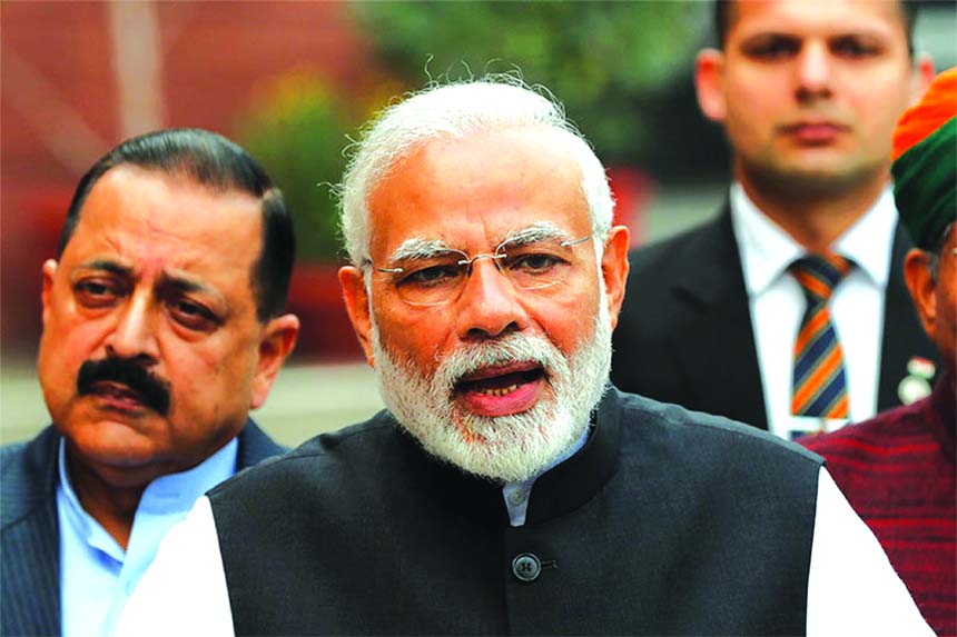 India's Prime Minister Narendra Modi speaks with the media inside the parliament premises on the first day of the winter session, in New Delhi.