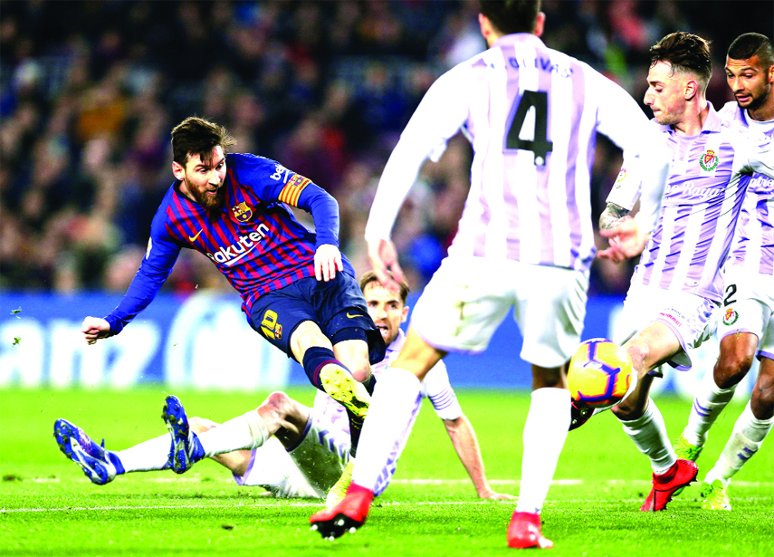 FC Barcelona's Lionel Messi (left) kicks the ball during the Spanish La Liga soccer match between FC Barcelona and Valladolid at the Camp Nou stadium in Barcelona, Spain on Saturday.