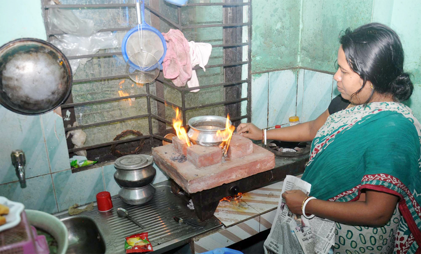 A housewife at Eidgah area using brick burner for cooking as gas crisis hits the Port City yesterday.