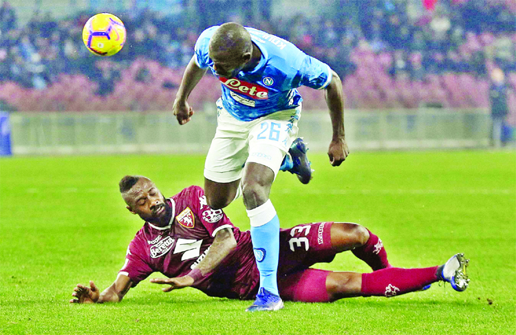 Torino's Nicolas Nkoulou (bottom) tackles Napoli's Kalidou Koulibaly during the Serie A soccer match between Napoli and Torino at the San Paolo stadium in Naples, Italy on Sunday.