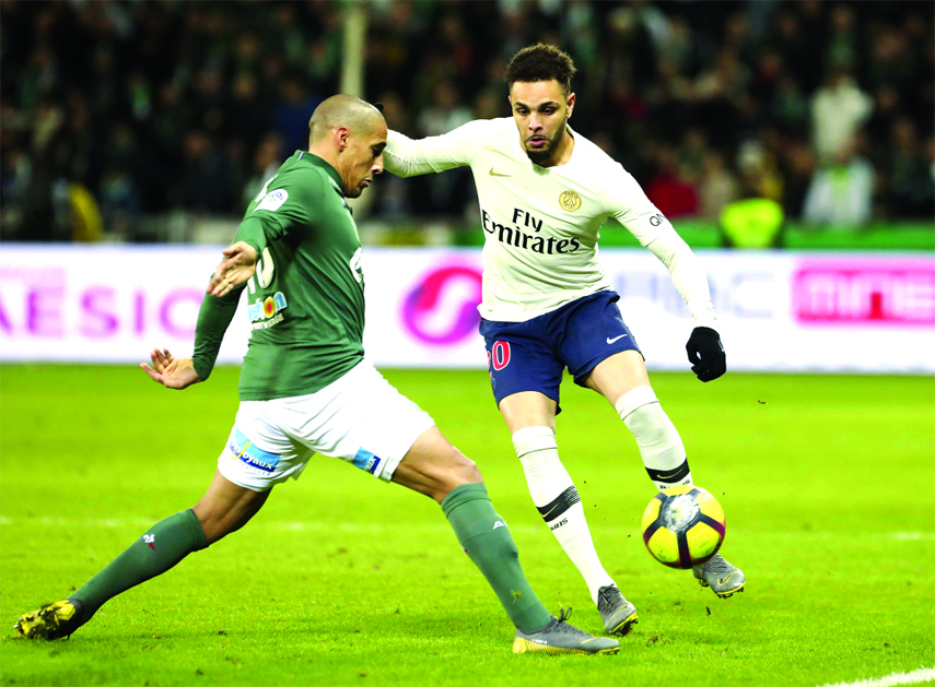 PSG defender Layvin Kurzawa (right) challenges for the ball with Saint-Etienne's Wahbi Khazri during the French League One soccer match between Saint-Etienne and Paris Saint-Germain, at the Geoffroy Guichard stadium in Saint-Etienne, central France on Su