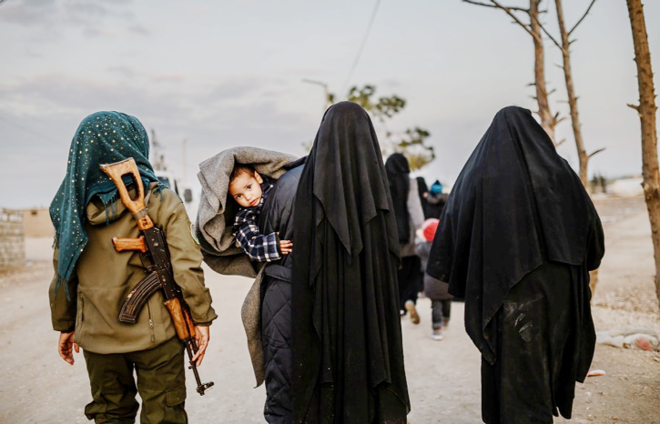 Syrian women and children walk ar al-Hasakeh, Syria, on Sunday.