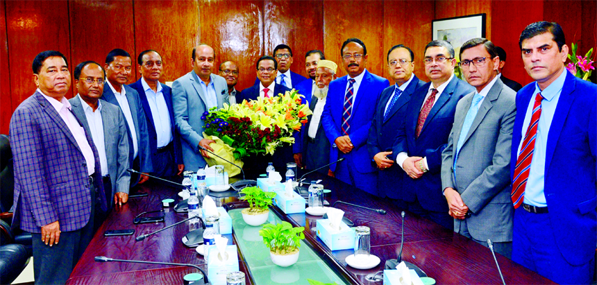 AKM Shaheed Reza, Chairman along with other top officials of Mercantile Bank Limited, bidding farewell with bouquet to Kazi Masihur Rahman, outgoing CEO of the bank upon his retirement from the service at Bank's head office on Tuesday.