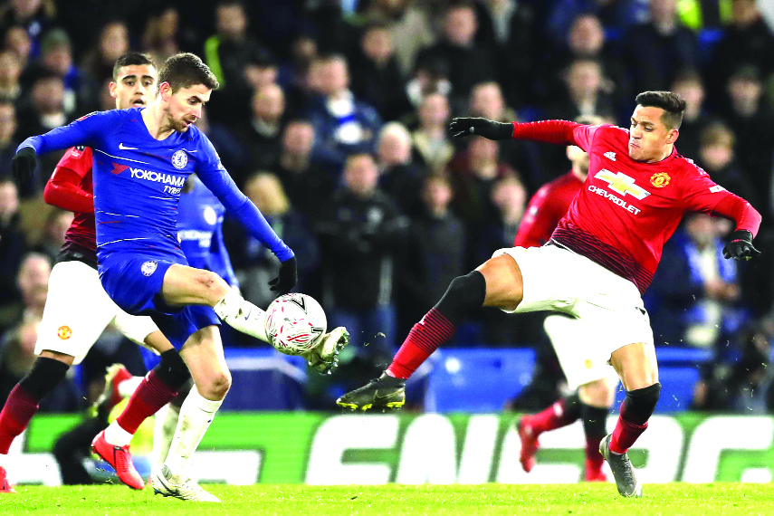 Chelsea's Jorginho (left) fights for the ball with Manchester United's Alexis Sanchez during the English FA Cup fifth round soccer match between Chelsea and Manchester United at Stamford Bridge stadium in London on Monday.