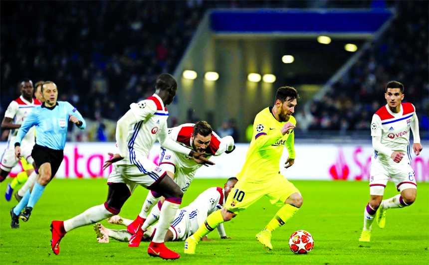 Barcelona forward Lionel Messi (2nd right) controls the ball during the Champions League round of 16, first leg soccer match between Lyon and FC Barcelona in Decines, near Lyon, central France on Tuesday.