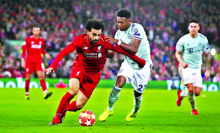 Liverpool's Mohamed Salah (left) and Bayern Munich's David Alaba battle for the ball, during the Champions League round of 16, first leg soccer match between Liverpool and Bayern Munich, at Anfield in Liverpool, England on Tuesday.
